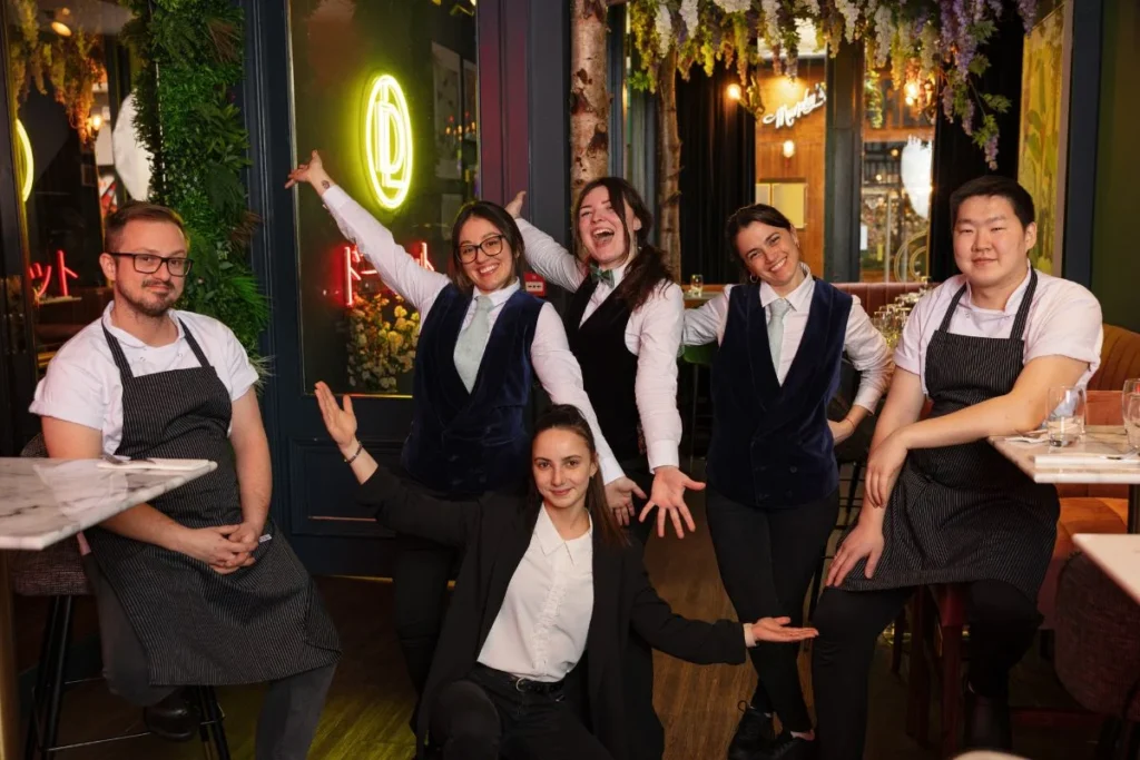 The welcoming team of a Temple Bar restaurant poses with joy, showcasing the friendly and professional staff ready to create an unforgettable dining experience.