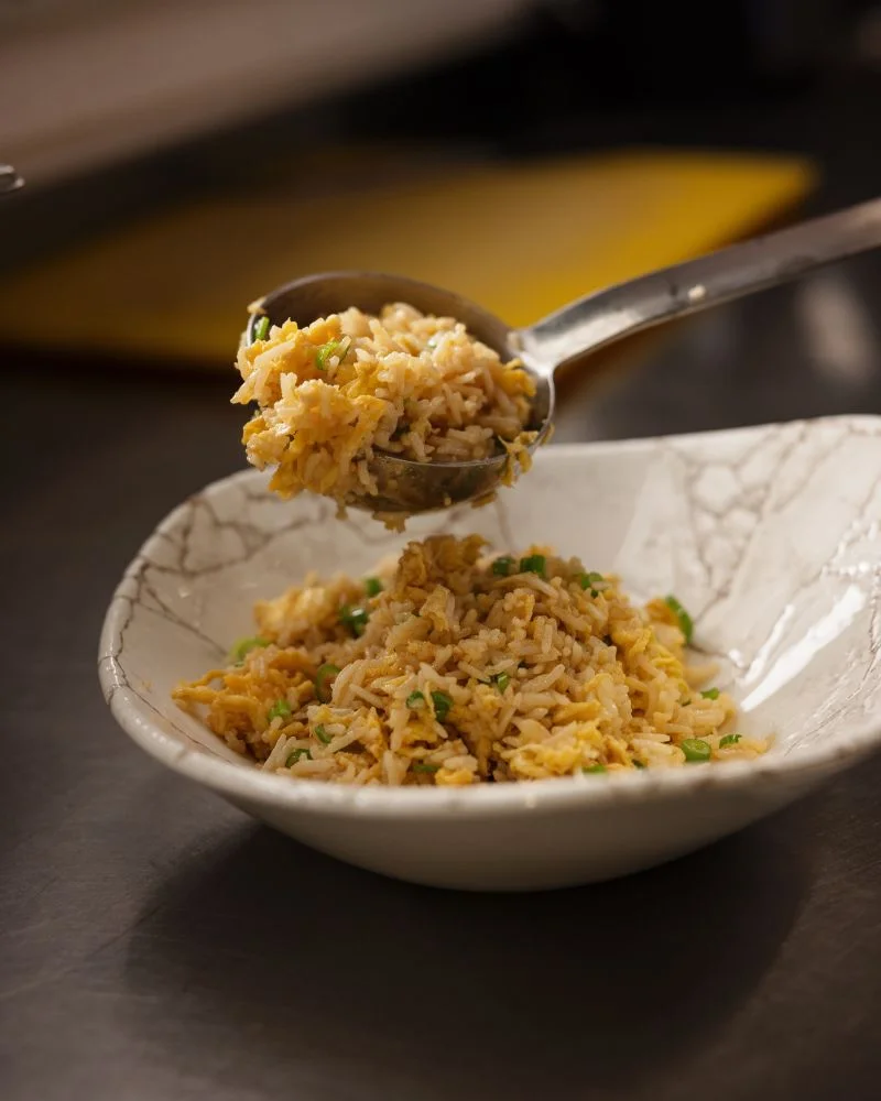 A bowl of aromatic fried rice being served, representing the Asian-inspired cuisine available at a Temple Bar restaurant.
